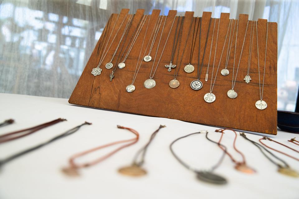 Necklaces made by Chris Zurovec sit on display the Rockport Art Festival on Saturday, July 2, 2022.