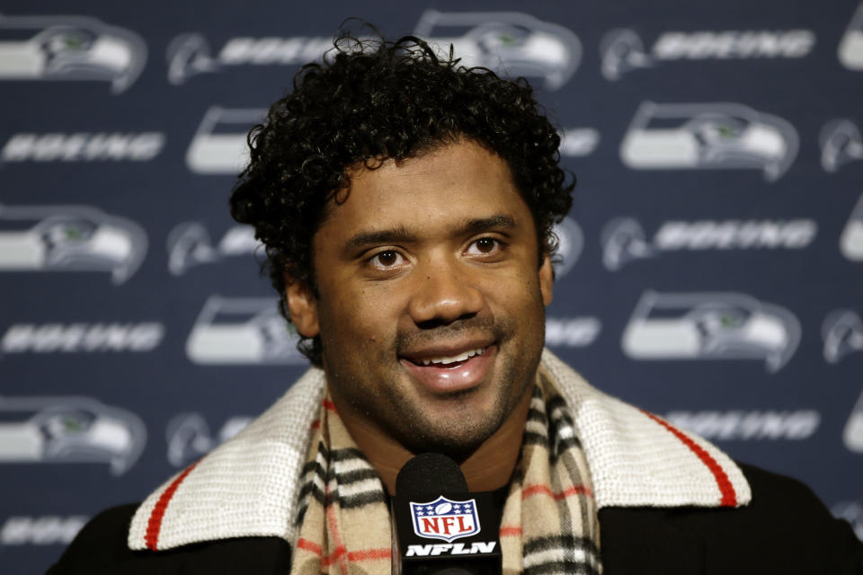 FILE - In this Nov. 24, 2019, file photo, Seattle Seahawks' Russell Wilson speaks during a news conference after an NFL football game against the Philadelphia Eagles in Philadelphia. Seahawks quarterback Russell Wilson, soccer star Megan Rapinoe and three-time WNBA champion Sue Bird will preside over The ESPYS two-hour broadcast airing June 21 on ESPN. All three live in the Seattle area. Rapinoe and Bird are partners who share a household, which conveniently eases some logistics. Wilson’s singer-wife, Ciara, is likely to make an appearance, too. (AP Photo/Matt Rourke, File)