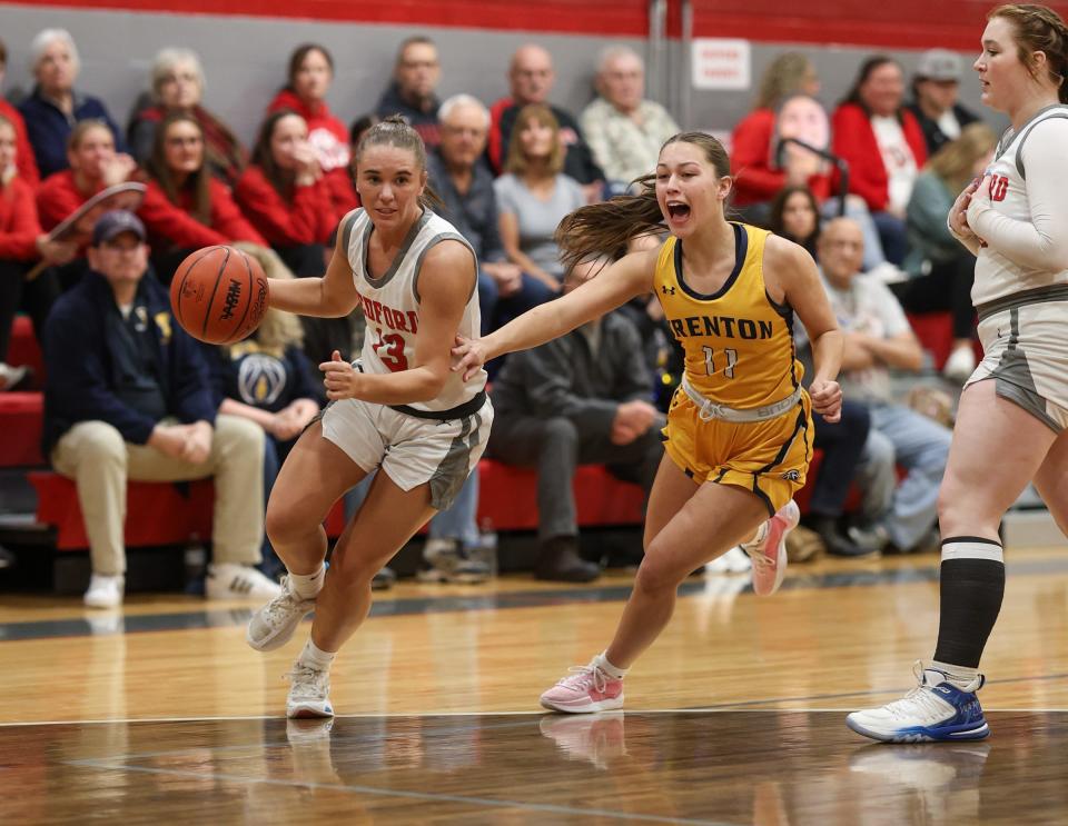 Bedford's Payton Pudlowski drives to the basket during a 74-33 victory over Trenton in the finals of the Division 1 District at Bedford on Friday, March 8, 2024.