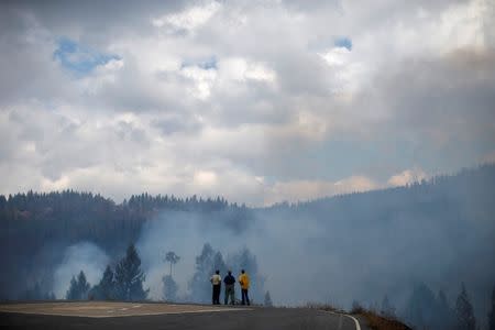 Fire officials monitor the King Fire from a heliport in Fresh Pond northeast of Sacramento, California September 18, 2014. REUTERS/Stephen Lam