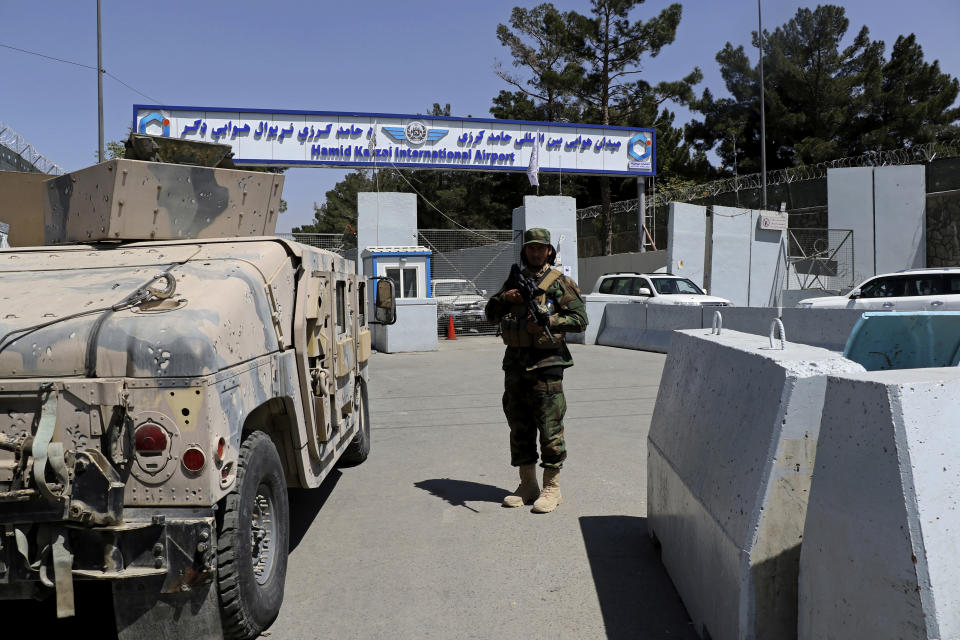 A Taliban soldier stands guard at the gate of Hamid Karzai International Airport in Kabul, Afghanistan, Sunday, Sept. 5, 2021. Some domestic flights have resumed at Kabul's airport, with the state-run Ariana Afghan Airlines operating flights to three provinces. (AP Photo/Wali Sabawoon)