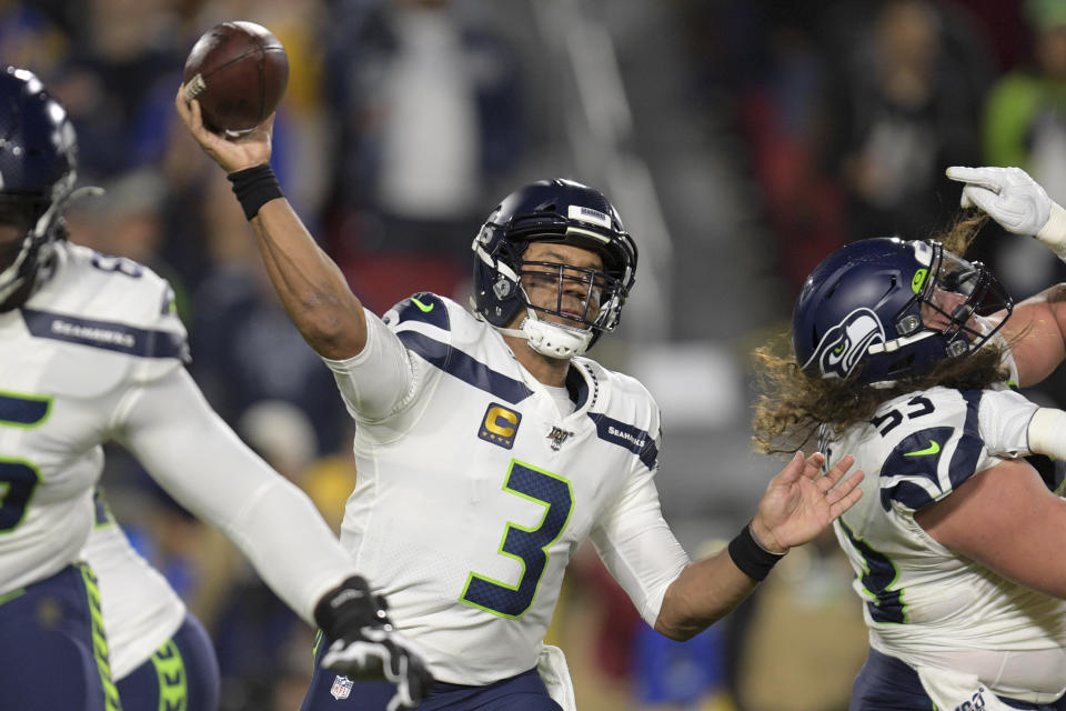 File-This Dec. 8, 2019, file photo shows Seattle Seahawks quarterback Russell Wilson passing during the first half of an NFL football game against the Los Angeles Rams in Los Angeles. No matter how many spectacular plays Lamar Jackson and Wilson made, officiating overshadowed the NFL this season. (AP Photo/Kyusung Gong, File)