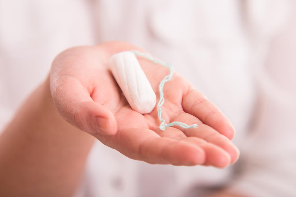 White woman's tampon on hand - close up