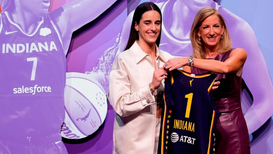 PHOTO: Iowa's Caitlin Clark, left, poses for a photo with WNBA commissioner Cathy Engelbert, right, after being selected first overall by the Indiana Fever during the first round of the WNBA basketball draft, April 15, 2024, in New York. (Adam Hunger/AP)