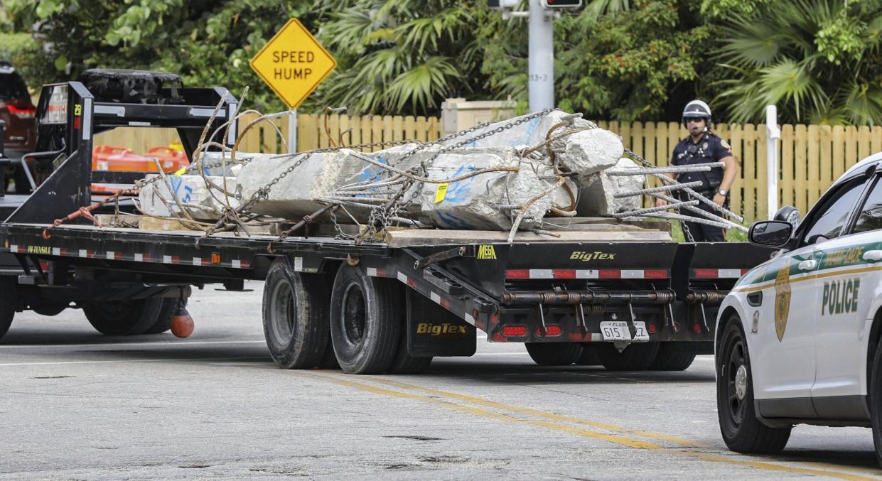 Large sections of concrete are transported from the debris field of the 12-story oceanfront condo, Champlain Towers South, in Surfside, Fla. on Wednesday, July 7, 2021. No one has been rescued alive from the site since the first hours after the building collapsed on June 24 when many of its residents were asleep.
