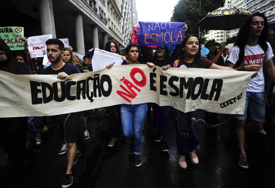 Students hold a banner that reads in Portuguese "Education is not charity" during a nation-wide education strike in Rio de Janeiro, Brazil, Wednesday, May 15, 2019. Federal education officials this month announced budget cuts of $1.85 billion for public education, part of a wider government effort to slash spending. (AP Photo/Bruna Prado)