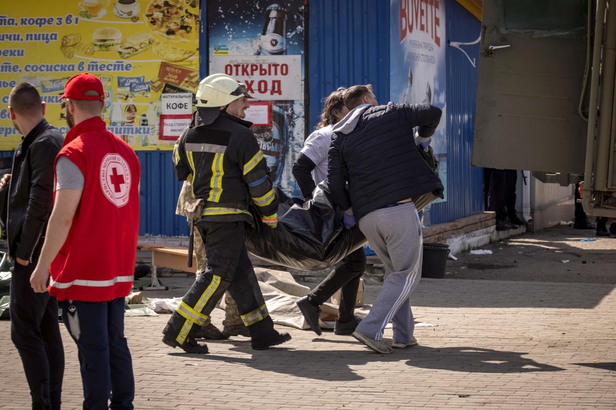 People load bodies on a military truck after a rocket attack at a train station in Kramatorsk, eastern Ukraine, that was being used for civilian evacuations. (AFP via Getty Images)