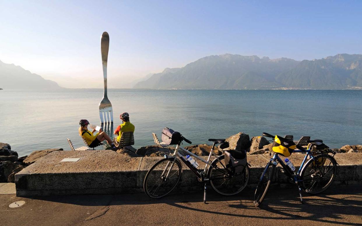 Biker at sculpture of Jean-Pierre Zaugg, La Fourchette, Vevey, Lake Geneva, Switzerland