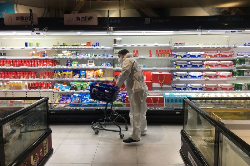 FILE PHOTO: Customer pushes a cart while shopping inside a supermarket of Alibaba's Hema Fresh chain, following an outbreak of the novel coronavirus in Wuhan