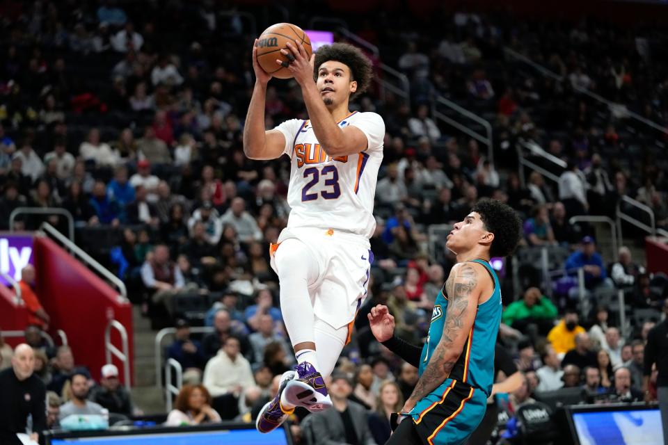 Phoenix Suns forward Cameron Johnson (23) drives on Detroit Pistons guard Killian Hayes (7) in the first half of an NBA basketball game in Detroit, Saturday, Feb. 4, 2023. (AP Photo/Paul Sancya)