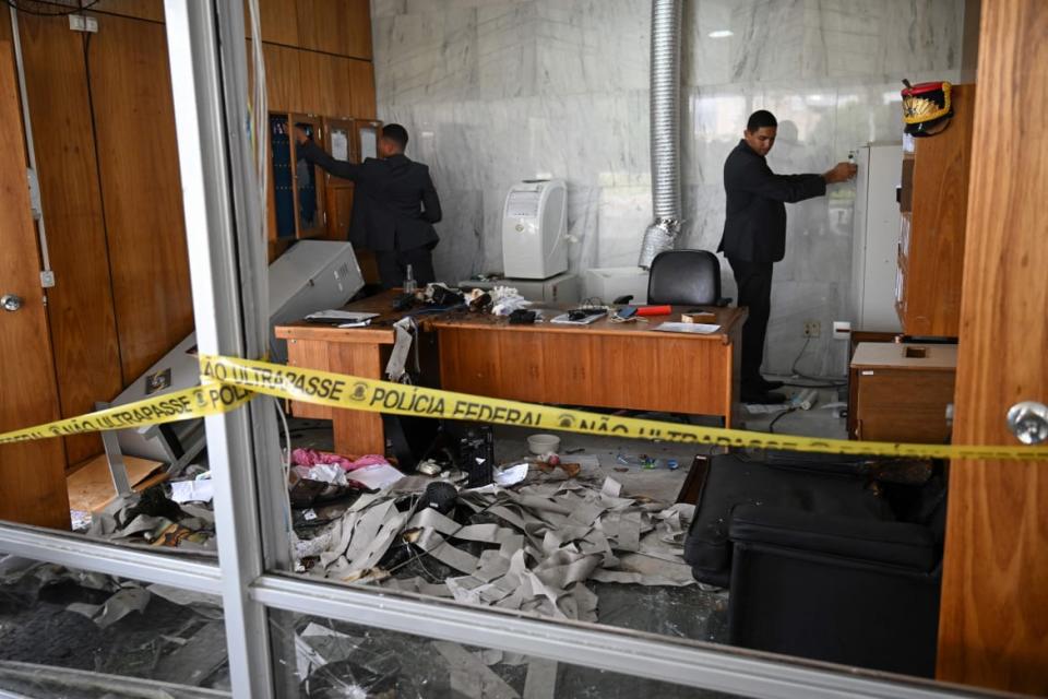 <div class="inline-image__caption"><p>Planalto Presidential Palace security members inspect offices destroyed by supporters of Brazilian former President Jair Bolsonaro after an invasion in Brasilia on January 9, 2023.</p></div> <div class="inline-image__credit">CARL DE SOUZA/AFP/Getty</div>