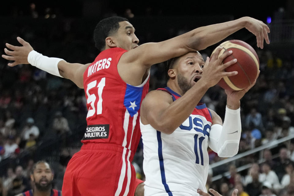 United States' Jalen Brunson, right, attempts to shoot around Puerto Rico's Tremont Waters during the first half of an exhibition basketball game Monday, Aug. 7, 2023, in Las Vegas. (AP Photo/John Locher)