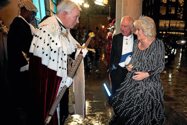 <p>KIRSTY WIGGLESWORTH/POOL/AFP via Getty</p> King Charles and Queen Camilla are presented with the Pearl Sword on Oct. 18, 2023