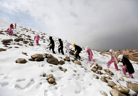 Students of the Shaolin Wushu club climb a hill as they arrive to practice in Kabul, Afghanistan January 29, 2017. REUTERS/Mohammad Ismail