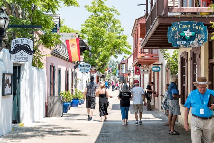 St George Street stores in downtown Florida city famous historic Spanish city, sunny day summer, people tourists walking