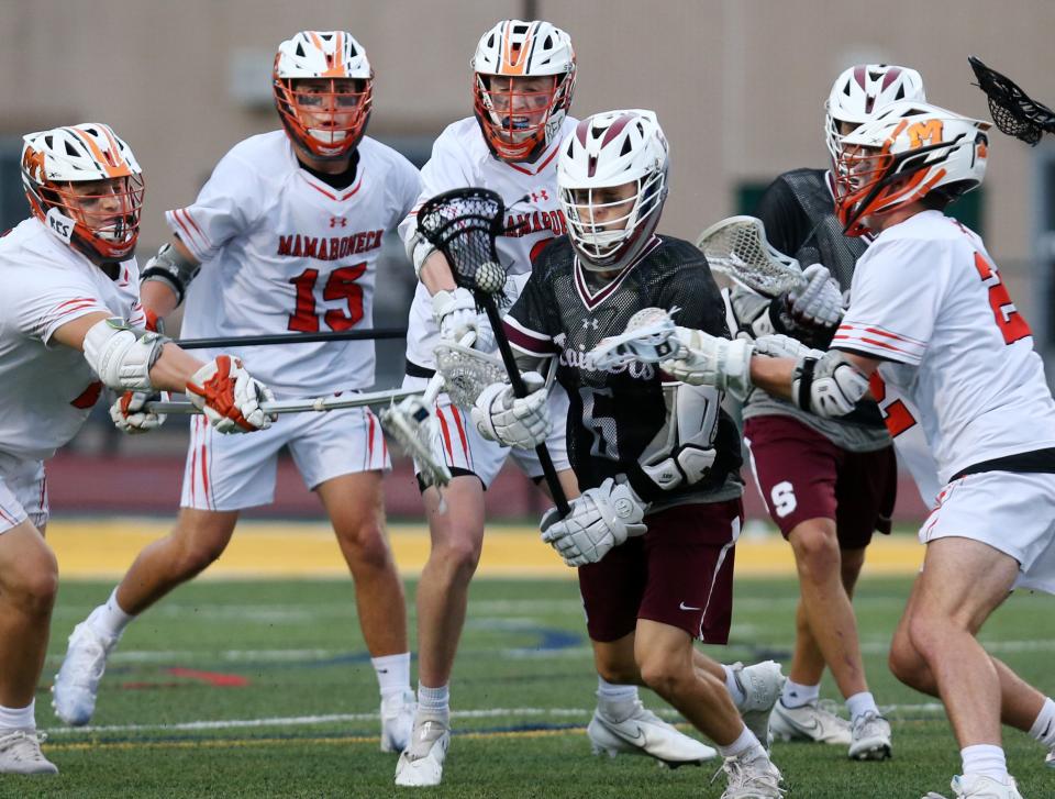 Scarsdale's Jacob Goldstein (6) tries to break away from a host of Mamaroneck defenders during the Section 1 Class A championship game at Lakeland High School in Shrub Oak May 27, 2022. Scarsdale won the game 12-7.