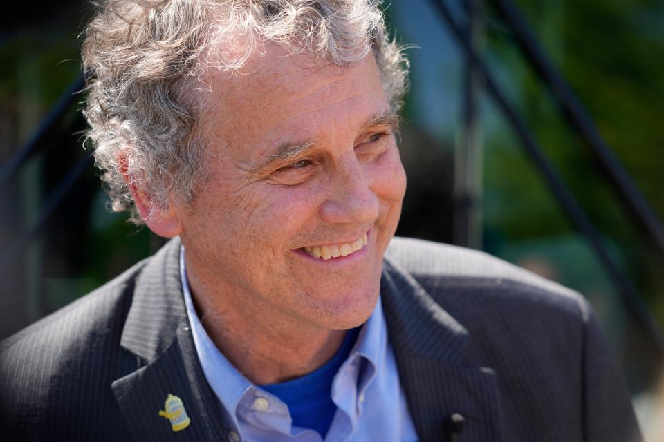 Jul 7, 2022; Columbus, Ohio, United States;  Sen. Sherrod Brown answers media questions after riding a COTA bus down Broad Street through Franklinton, the route that will eventually be part of the LinkUS bus rapid transit system, with COTA president and CEO Joanna Pinkerton, on July 7, 2022. Mandatory Credit: Adam Cairns-The Columbus Dispatch