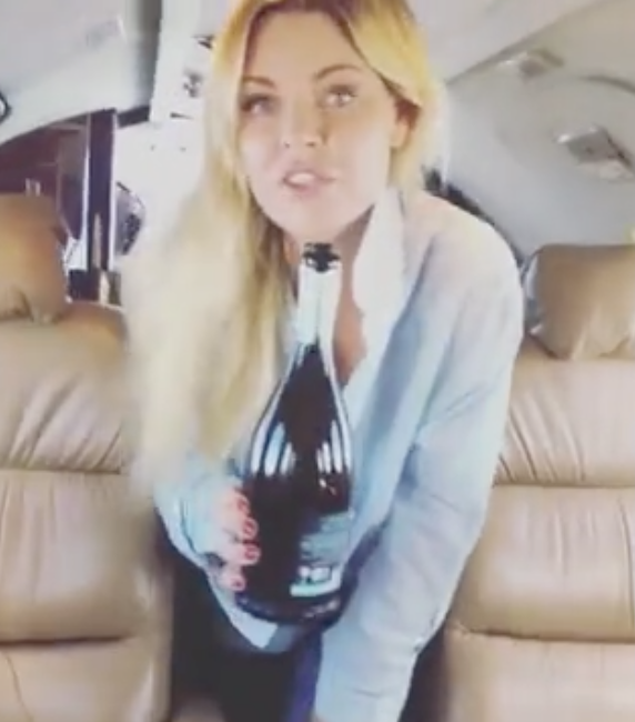 She also posted a video of her serving up champagne on a private jet. Photo: Instagram/sophiemonk