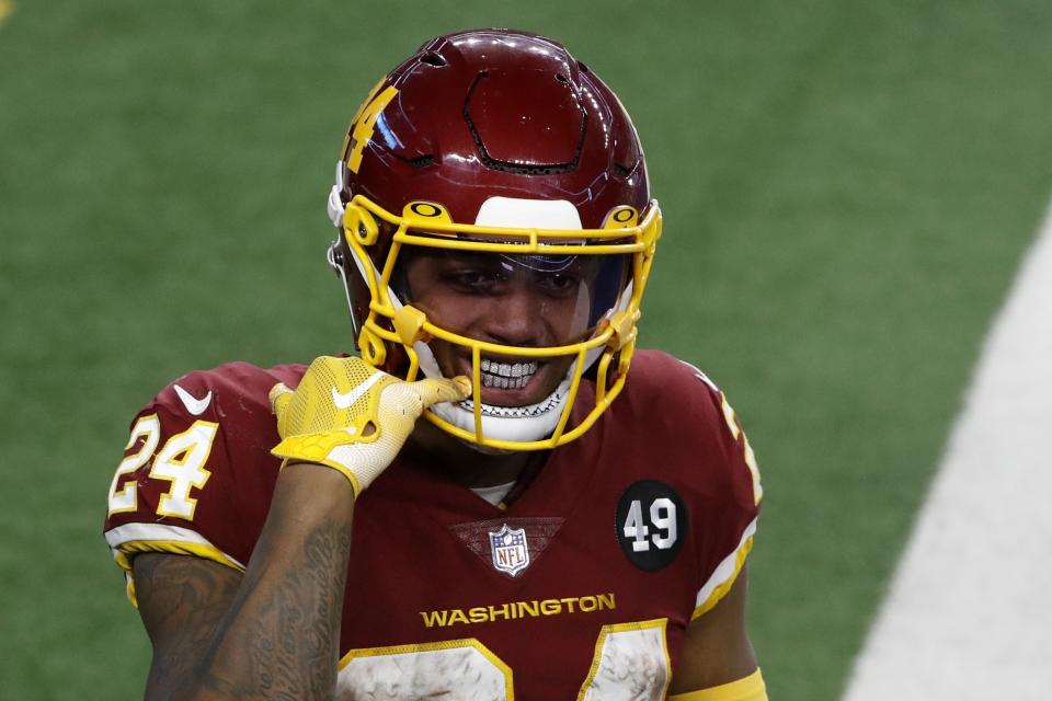 Washington Football Team running back Antonio Gibson (24) points to his mouth as he celebrates his touchdown in the second half of an NFL football game against the Dallas Cowboys in Arlington, Texas, Thursday, Nov. 26, 2020. (AP Photo/Roger Steinman)