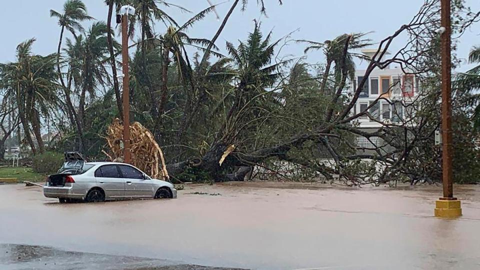 The waters of the Hagatna River overflows its banks and encroaches into the Bank of Guam parking lot in Hagatna, Guam, Thursday, May 25, 2023, in the aftermath of Typhoon Mawar (AP)