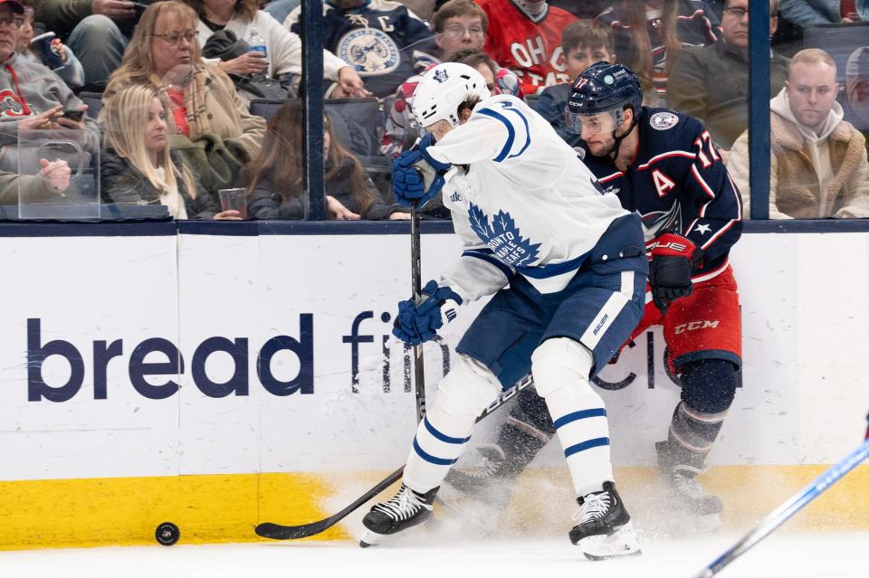 Dec 29, 2023; Columbus, Ohio, USA;
Columbus Blue Jackets right wing Justin Danforth (17) fights against Toronto Maple Leafs defender for the puck during the third period of their game against the Toronto Maple Leafs on Friday, Dec. 29, 2023 at Nationwide Arena.