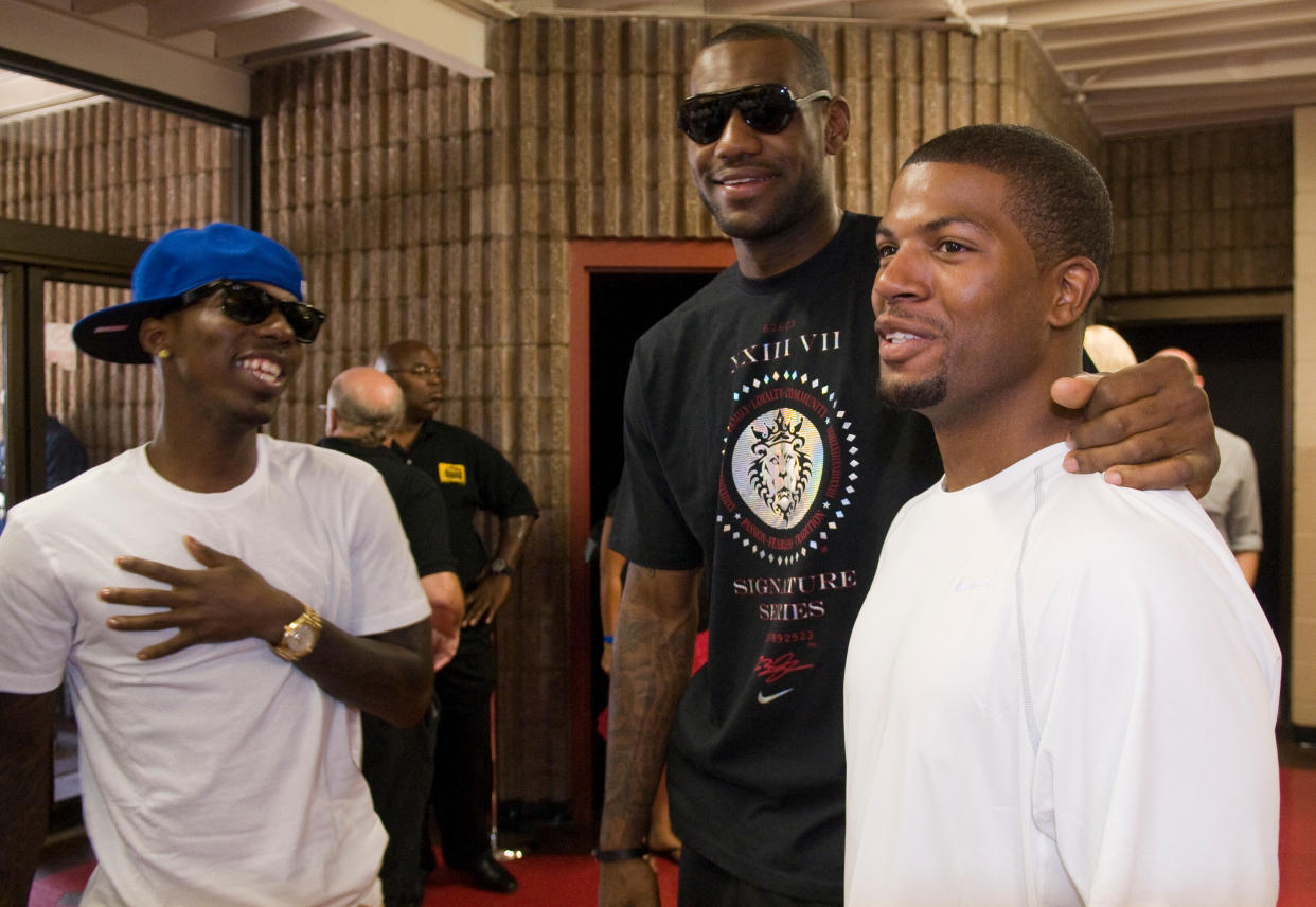 Cleveland Cavaliers forward LeBron James, center, talks with Rich Paul, left, and former high school teammate Brandon Weems, right, before an event where James revealed his new Nike Air Max LeBron VII shoes during an event at Ed Davis Community Center in Akron, Ohio on Friday, Aug. 7, 2009 in Cleveland, Ohio. (AP Photo/Jason Miller)