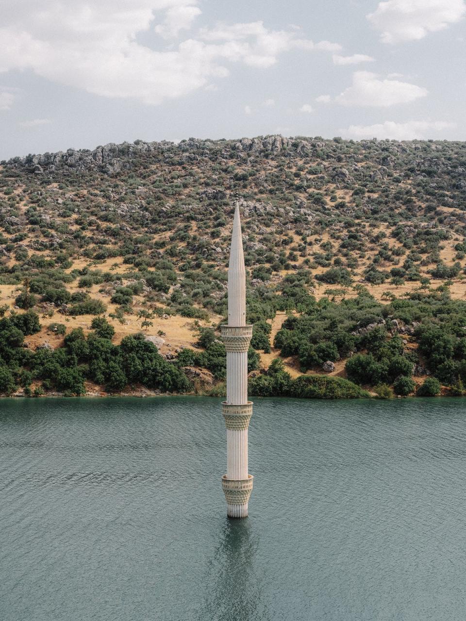 The minaret of a sunken mosque emerges from the reservoir of the Birecik dam in Gaziantep. For several decades now, dozens of villages and towns have disappeared under water as a result of the numerous hydroelectric power plant projects of successive governments under the Southeast Anatolia Project (Emin Ozmen/Magnum Photos)