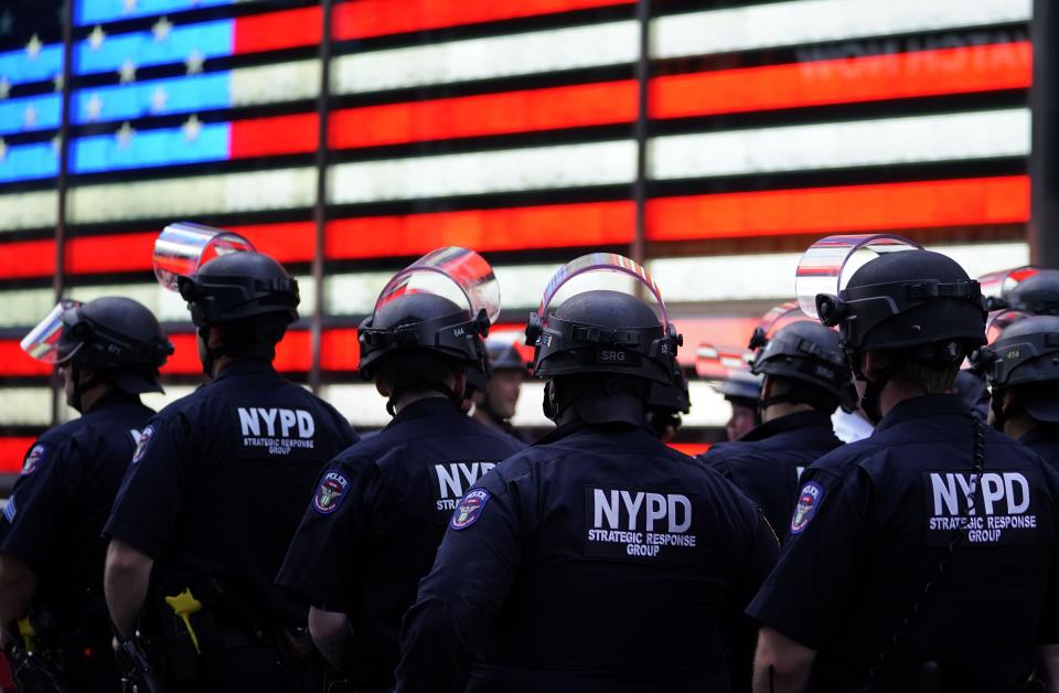 NYPD police officers watch demonstrators in Times Square on June 1, 2020, during a "Black Lives Matter" protest.