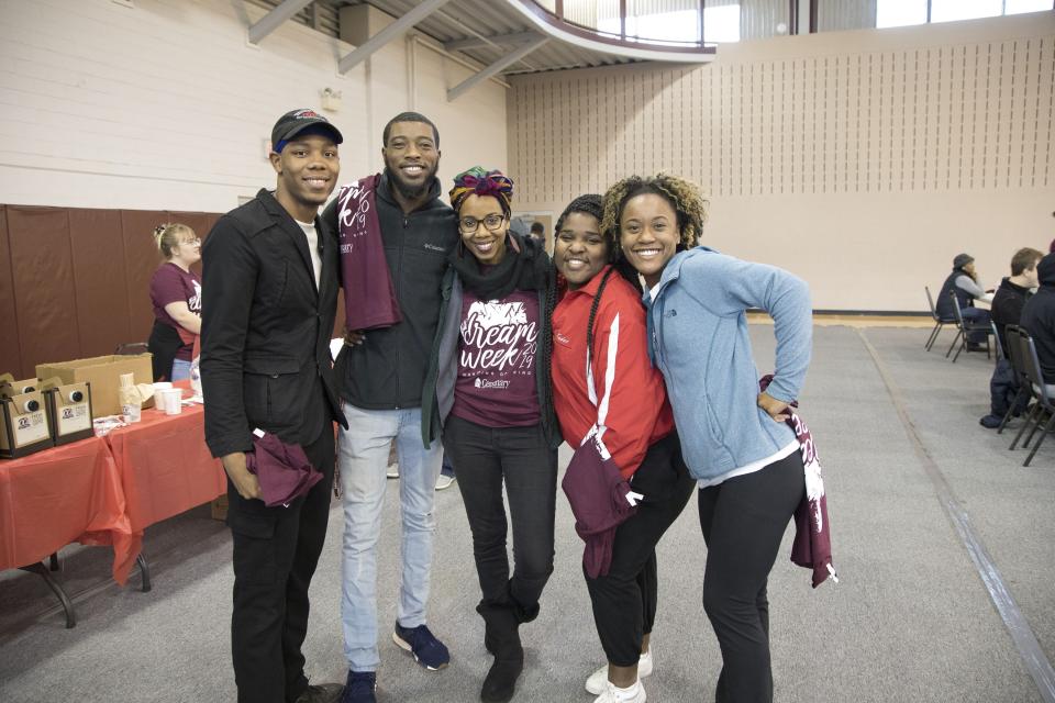 In this photo provided by Centenary College of Louisiana, associate professor Andia Augustin-Billy poses with students at the MLK Service Day event on Jan. 20, 2019, to kick off Centenary College of Louisiana's annual Dream Week, a celebration of the life and legacy of Dr. Martin Luther King, Jr., in Shreveport, La. At 196 years Louisiana's oldest college, Centenary plans a gathering Thursday, Nov. 4, 2021, to honor Augustin-Billy as the first Black person to gain tenure there. (Sherry Heflin/Centenary College of Louisiana via AP)