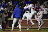 New York Mets' Brandon Nimmo, center, celebrates with Francisco Lindor (12) and other teammates after scoring a game-winning two-run home run during the ninth inning of a baseball game against the Atlanta Braves, Sunday, May 12, 2024, in New York. The Mets won 4-3. (AP Photo/Julia Nikhinson)