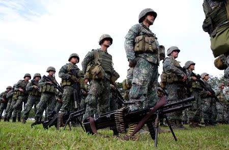 Philippine Marine Battalion Landing Team (MBLT) stands on attention during their send-off ceremony ending their combat duty against pro-Islamic State militant groups inside a military headquarters in Marawi city, southern Philippines October 21, 2017, a few days after President Rodrigo Duterte announced the liberation of Marawi city. REUTERS/Romeo Ranoco