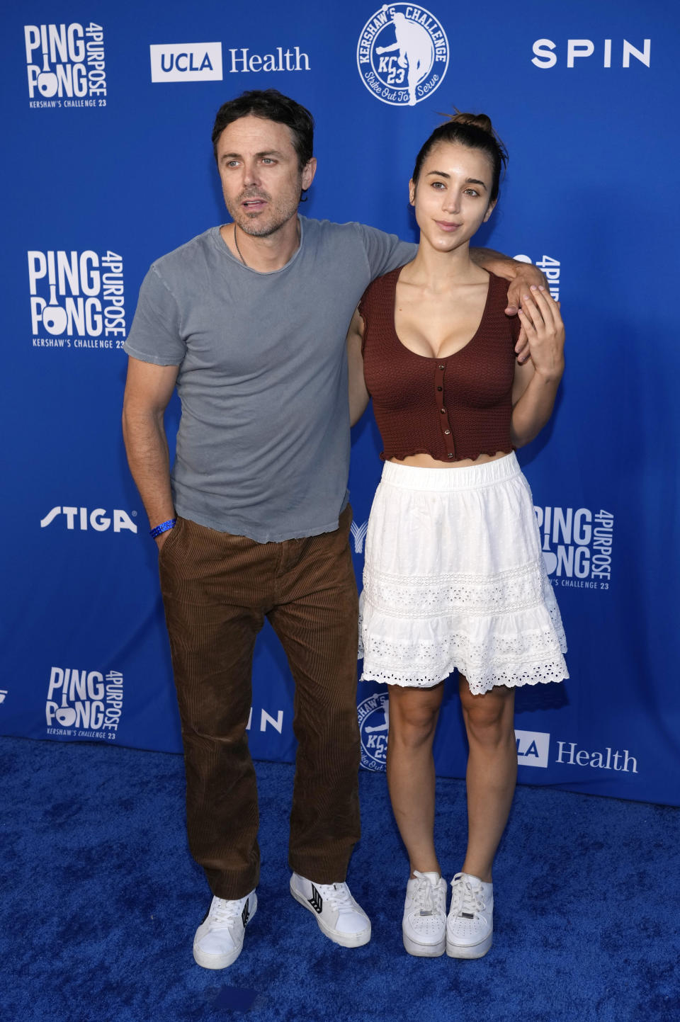 Actor Casey Affleck and his girlfriend, Caylee Cowan, pose together at the 10th Annual PingPong4Purpose celebrity ping pong tournament hosted by Los Angeles Dodgers pitcher Clayton Kershaw and his wife, Ellen, Thursday, July 27, 2023, at Dodger Stadium in Los Angeles. (AP Photo/Chris Pizzello)