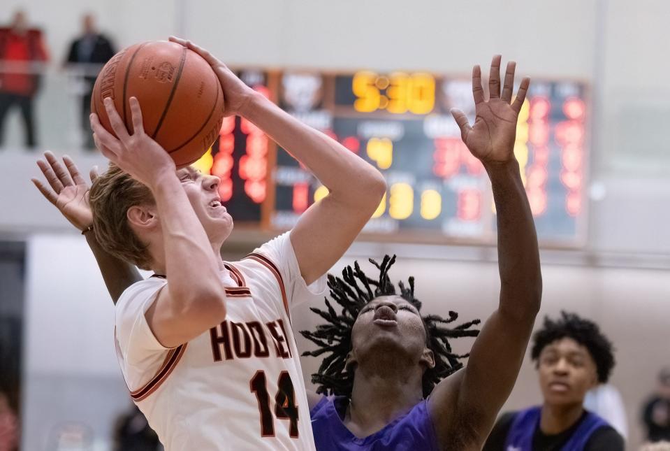 Hoover’s Crew Cain shoots over Barberton’s Robert Davis during the Hoover Hoops MLK Classic on Sunday, Jan. 14, 2024.
