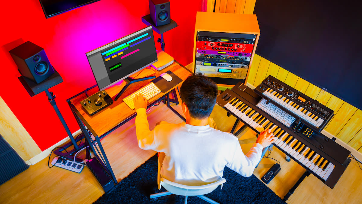  Overhead shot of man in studio recording keyboards 