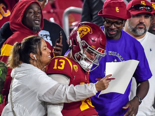 <p>Louis Lopez/CSM/Shutterstock</p> Caleb Williams with his family after the NCAA football game between the USC Trojans and the Washington Huskies on November 4, 2023.
