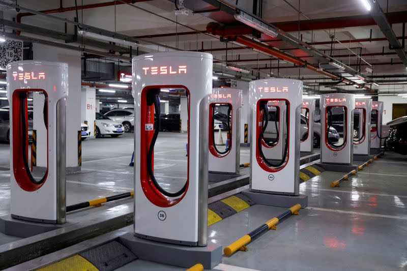 FILE PHOTO: Tesla charging stations are pictured in a parking lot in Shanghai