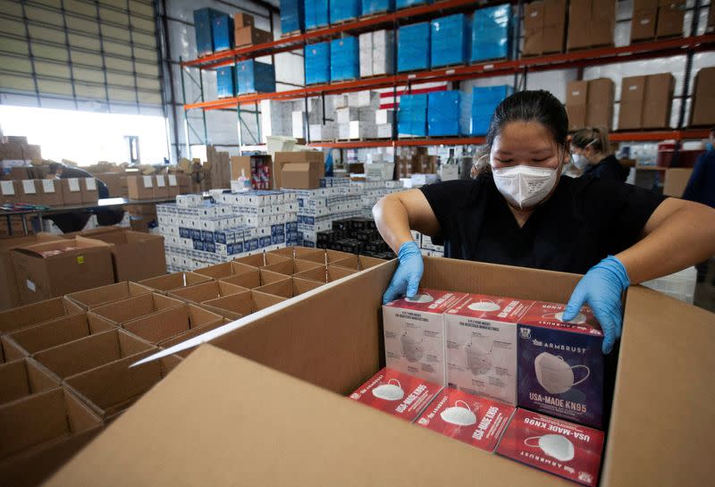 FILE PHOTO: An operator for Armbrust American prepares masks for shipping