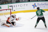 Dallas Stars left wing Jason Robertson (21) scores on a shootout-attempt against Anaheim Ducks goaltender John Gibson (36) in an NHL hockey game, Monday, Feb. 6, 2023, in Dallas. (AP Photo/Tony Gutierrez)