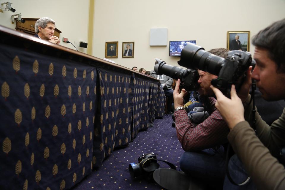 Kerry listens to opening statements as he waits to testify on agreements over Iran's nuclear programs, before the House Foreign Affairs Committee on Capitol Hill in Washington