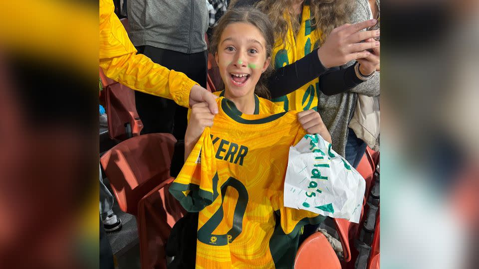 Zara Borcak beams as she holds the jersey Sam Kerr gave her after Saturday's match against France, August 12, 2023. - Selma Borcak