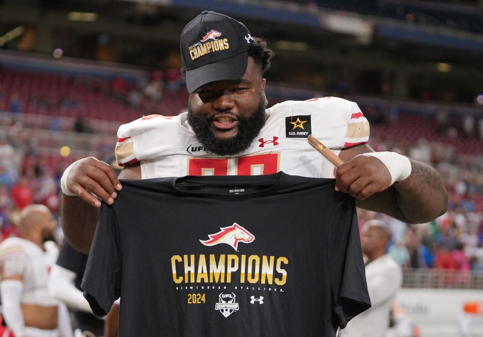 The Birmingham Stallions' Willie Yarbary holds his champions t-shirt after the team defeated the San Antonio Brahmas to win the UFL championship.