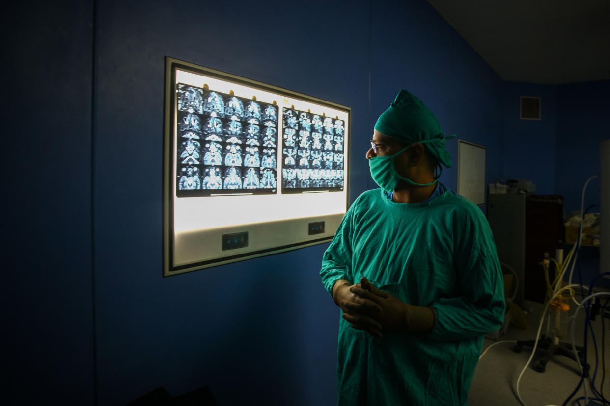 ALLAHABAD, INDIA - JUNE 05: Ear, nose and throat (ENT) specialist Dr. Sachin Jain checks an MRI report before performing surgery to remove mucormycosis, a rare but potentially deadly fungal infection, from a patient who recovered from Covid-19 at Swaroop Rani hospital on June 5, 2021, in Allahabad, India. (Ritesh Shukla / Getty Images file)