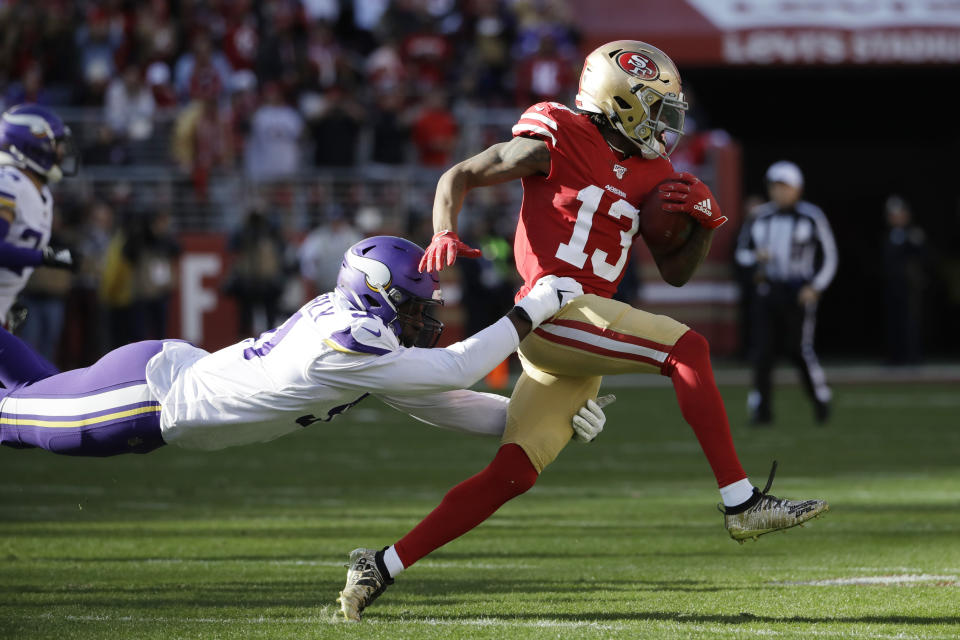 San Francisco 49ers wide receiver Richie James Jr. (13) tries to fend off a tackle by Minnesota Vikings defensive end Stephen Weatherly during the first half of an NFL divisional playoff football game, Saturday, Jan. 11, 2020, in Santa Clara, Calif. (AP Photo/Marcio Jose Sanchez)