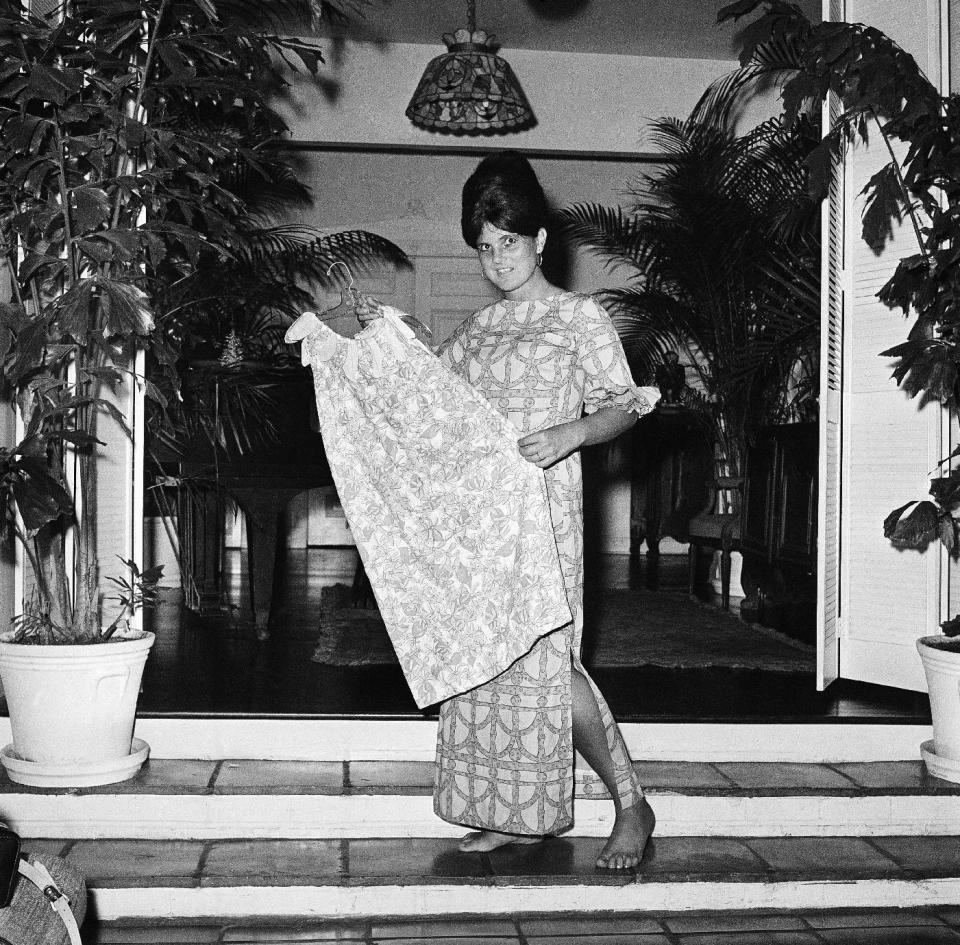 FILE - In this March 16, 1965 file photo, Palm Beach the fashion designer Lilly Pulitzer, wears her own design and creation of the Lilly shift, in Palm Beach, Fla. Pulitzer, known for her tropical print dresses, died in Florida at 81 on Sunday, April, 7, 2013. (AP Photo/Robert H. Houston, File)