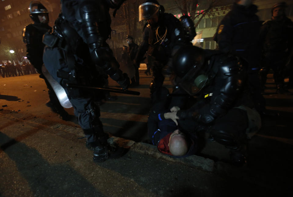 Bosnian police detain a man during a protest in Bosnian town of Tuzla, 140 kms north of Sarajevo, on Thursday, Feb. 6. 2014. Violent protests by some thousands of unpaid workers in a northern Bosnian city spread to other parts of the country Thursday and have morphed into widespread discontent about unemployment and alleged rampant corruption, in an election year. Police used tear gas to temporarily disperse the protesters in Tuzla who threw stones at a local government building, then the protesters returned after the tear gas volley, surrounded the empty government building and set tyres and trash on fire. (AP Photo/Amel Emric)