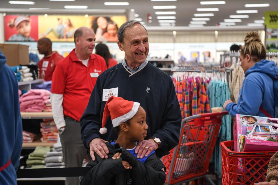 Bill Weigel and youngster Laranda Petty shop at the 26th annual Weigel's Family Christmas at Target on Dec. 2. The event, which started in 1998, allows children to each spend $200 on gifts. This year, 440 volunteers served 278 children.
