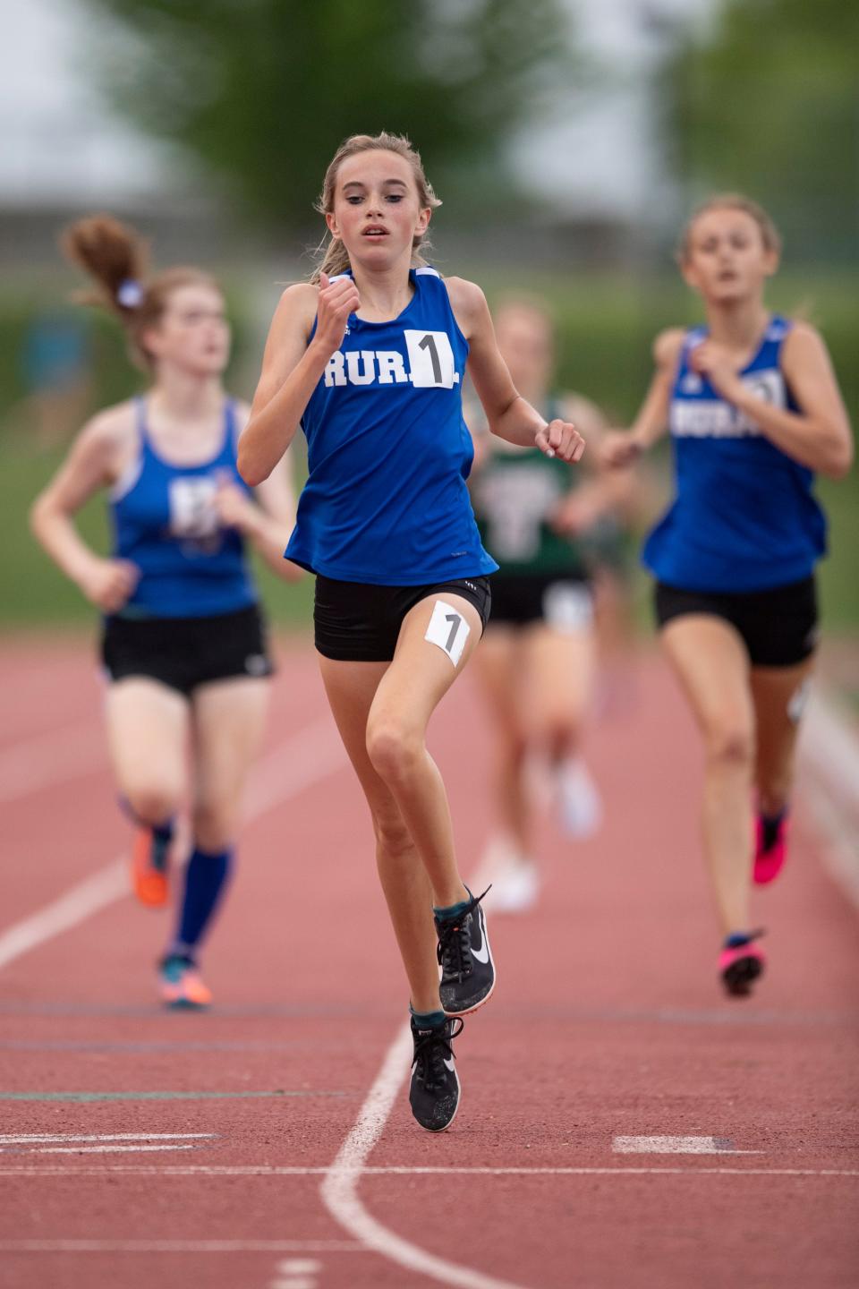 Washburn Rural's Payton Fink (1) crosses the finish line while competing in the girls 3200 meter during 6A regionals Thursday at Hummer Sports Park.