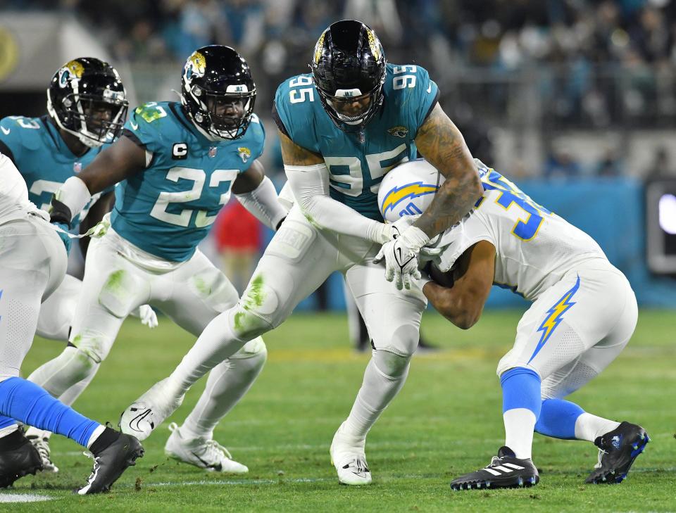 Jacksonville Jaguars defensive end Roy Robertson-Harris (95) makes the stop on Los Angeles Chargers running back Austin Ekeler (30) for no gain late in the third quarter. The Jacksonville Jaguars hosted the Los Angeles Chargers in their first round playoff game Saturday, January 14, 2023 at TIAA Bank Field in Jacksonville, Fla. The Jaguars trailed 27 to 7 at the half but came back to win the game 31 to 30. [Bob Self/Florida Times-Union]
