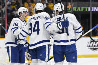 Toronto Maple Leafs center John Tavares (91) celebrates with Mitchell Marner (16) and Auston Matthews (34) after his goal against the Nashville Predators during the first period of an NHL hockey game Sunday, March 26, 2023, in Nashville, Tenn. (AP Photo/Mark Zaleski)