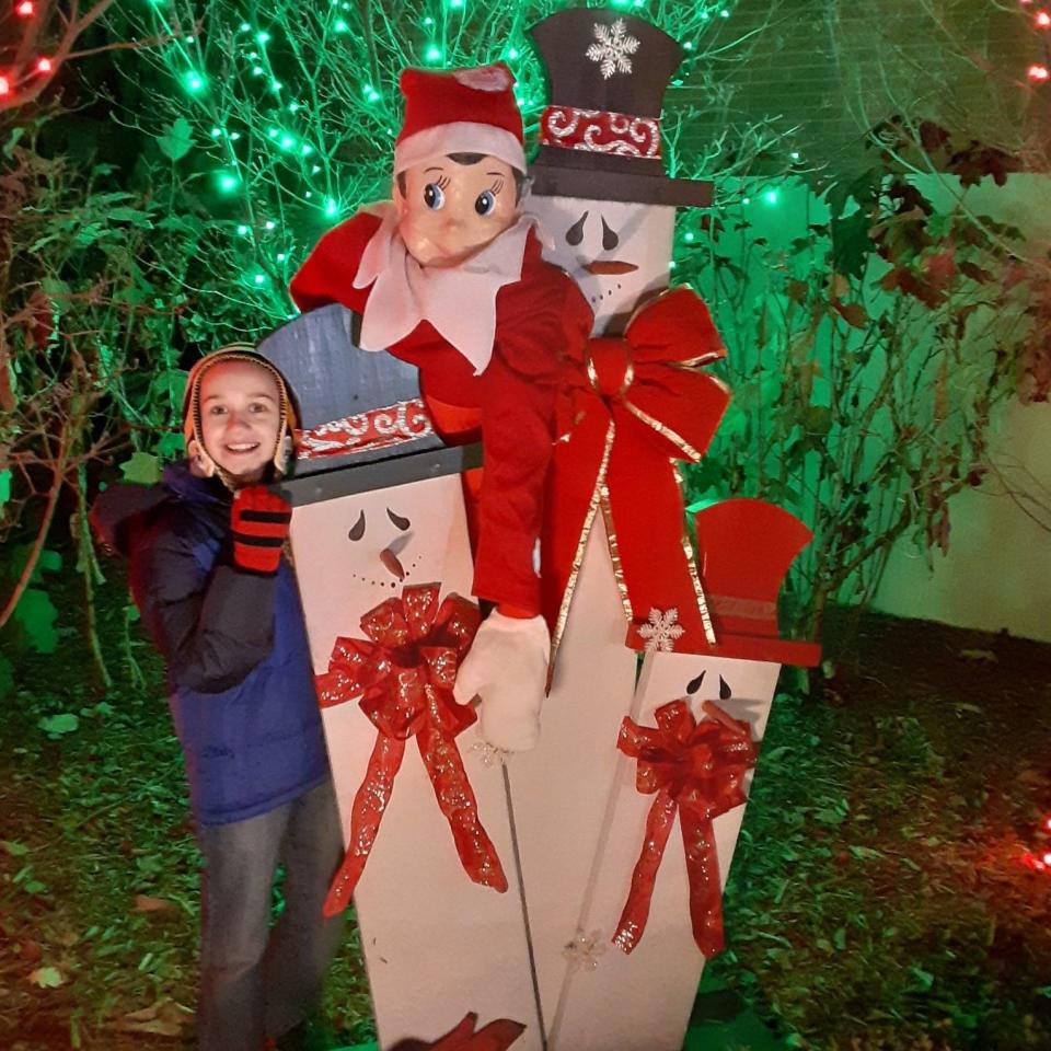 A young visitor takes a "Selfie with an Elfie" and earns a chance for prizes.